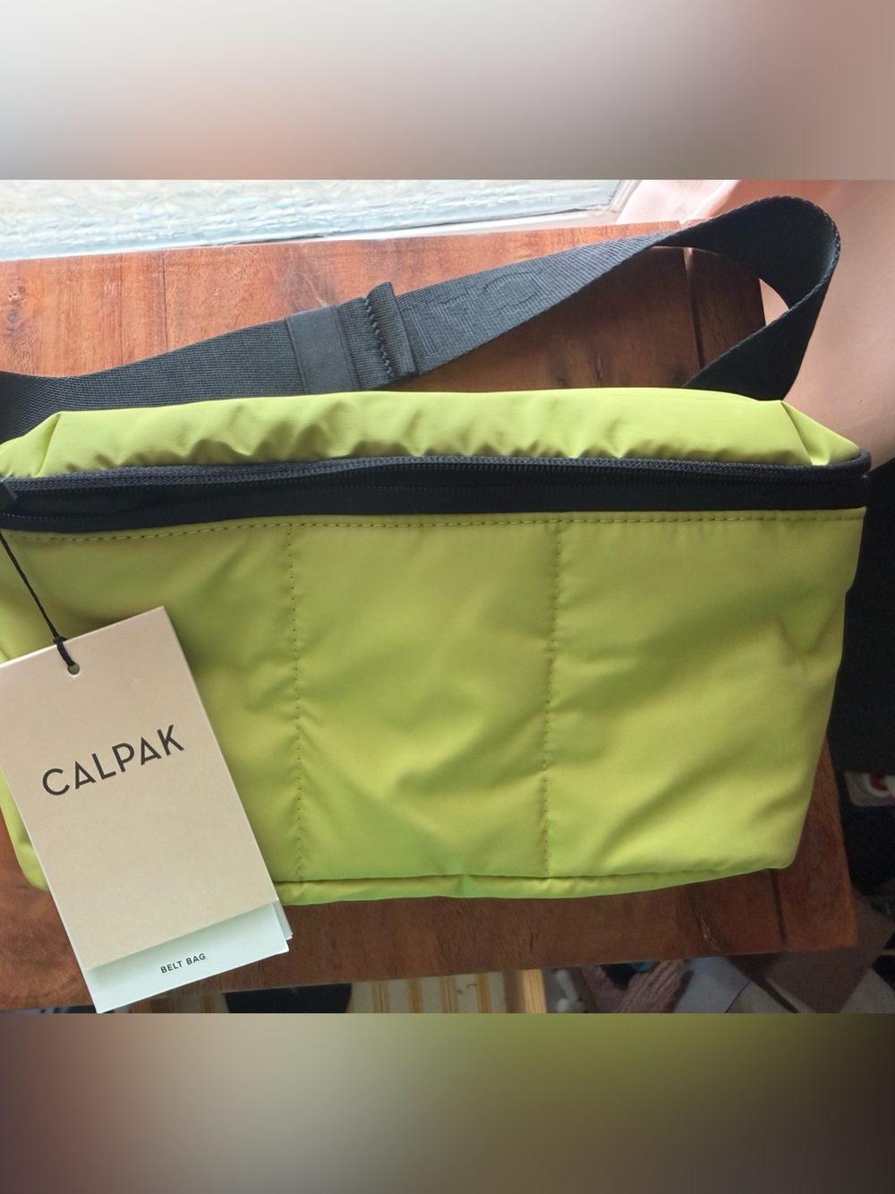 NWT CALPAK kiwi Green Sling Belt Bag with Black Strap